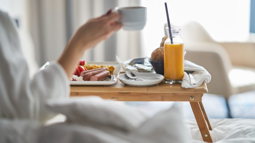 Breakfast in bed, cozy hotel room. concept