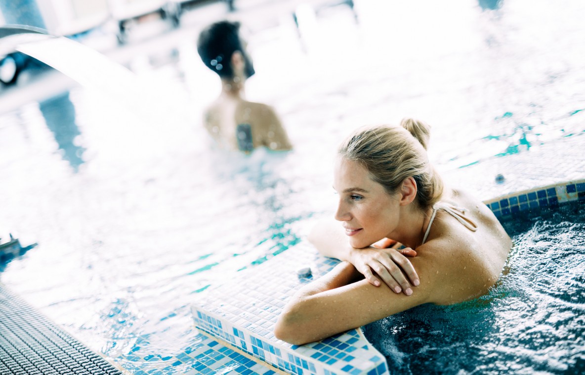 Portrait of beautiful woman relaxing in spa swimming pool